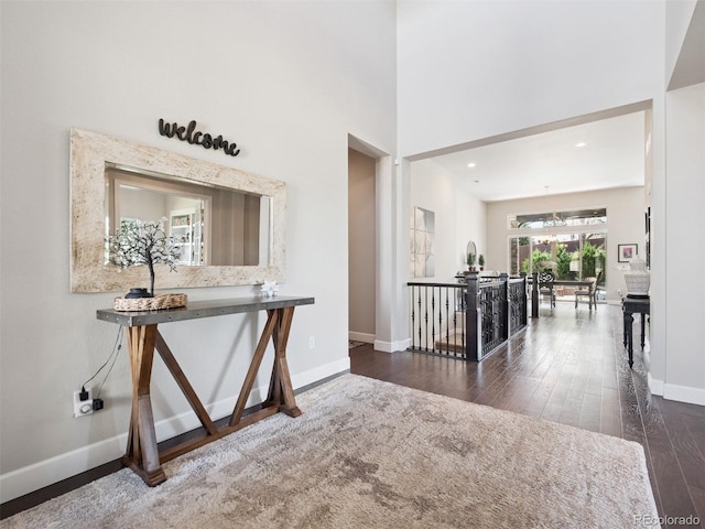 6970 E Lake Dr, Centennial, CO 80111 - hallway featuring wood-type flooring, baseboards, and a high ceiling