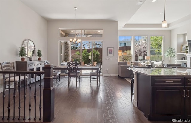 6970 E Lake Dr, Centennial, CO 80111 - kitchen with a notable chandelier, dark stone counters, open floor plan, dark wood-type flooring, and pendant lighting
