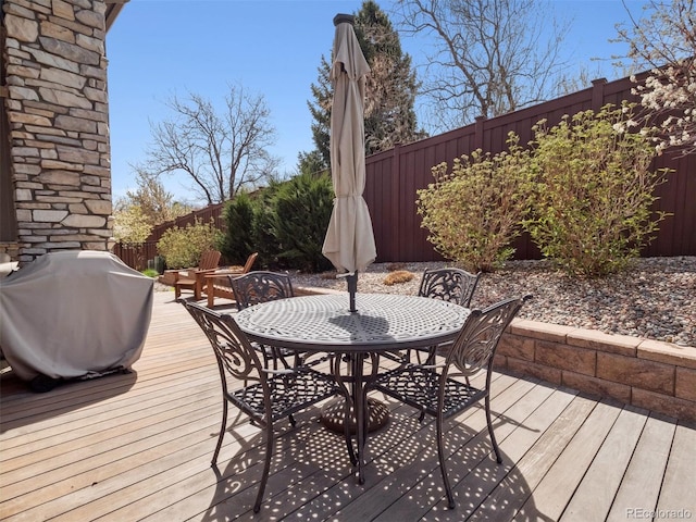 6970 E Lake Dr, Centennial, CO 80111 - deck featuring outdoor dining area, a fenced backyard, and a grill