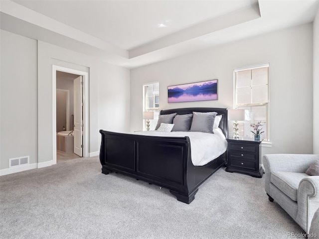 6970 E Lake Dr, Centennial, CO 80111 - bedroom featuring connected bathroom, light colored carpet, baseboards, a tray ceiling, and visible vents