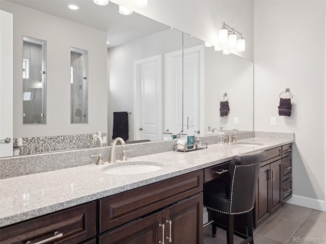 6970 E Lake Dr, Centennial, CO 80111 - full bath with a sink, baseboards, tile patterned flooring, and double vanity