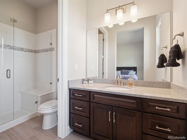 6970 E Lake Dr, Centennial, CO 80111 - bathroom featuring vanity, ensuite bathroom, toilet, and a shower stall