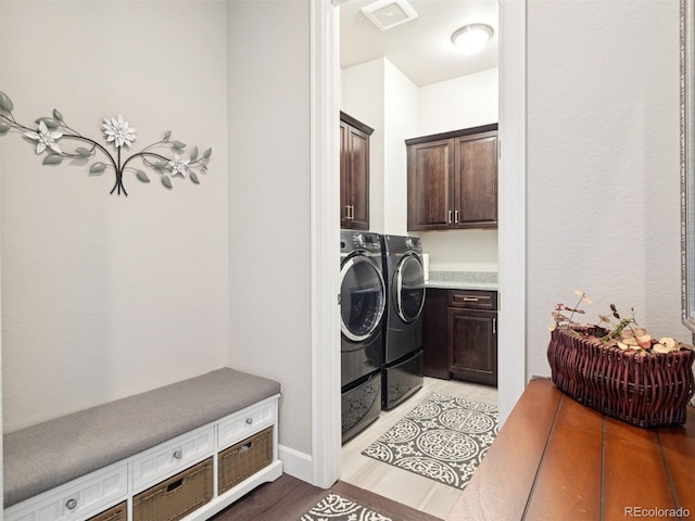 6970 E Lake Dr, Centennial, CO 80111 - laundry area featuring cabinet space, independent washer and dryer, and light wood-type flooring