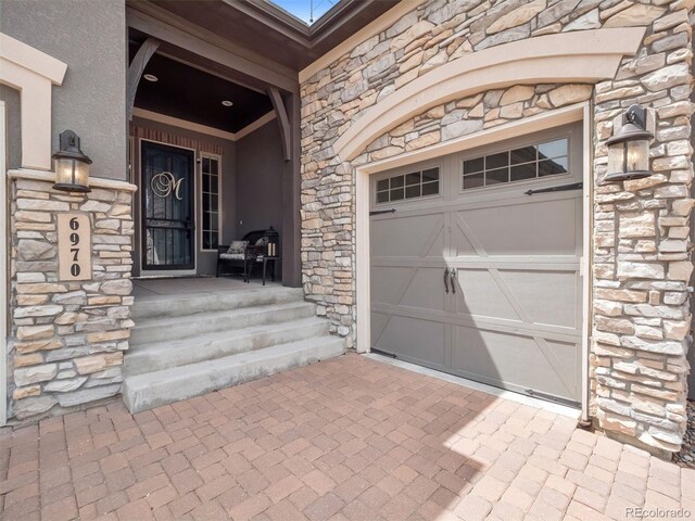 6970 E Lake Dr, Centennial, CO 80111 - property entrance with a porch, decorative driveway, and stone siding