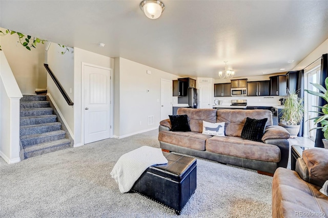 living room featuring light carpet and a notable chandelier