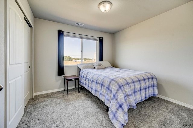 carpeted bedroom with a closet