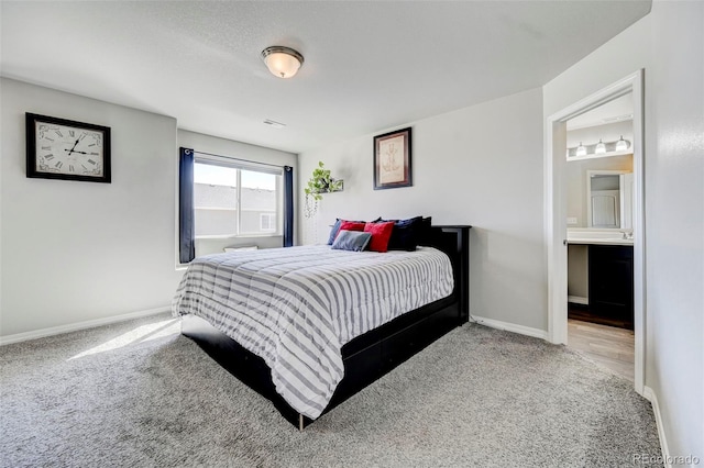 bedroom featuring connected bathroom and carpet