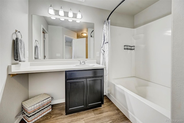 bathroom with hardwood / wood-style floors, vanity, and shower / bath combination with curtain