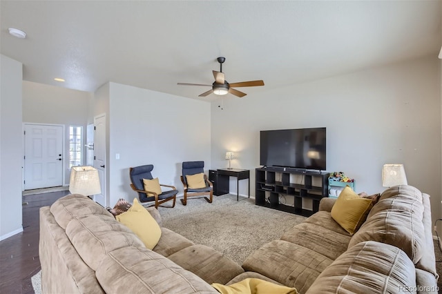 living room featuring ceiling fan and dark hardwood / wood-style floors