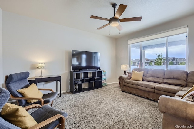 carpeted living room featuring ceiling fan