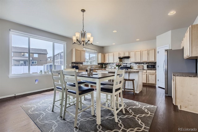 dining area featuring dark hardwood / wood-style flooring and a notable chandelier