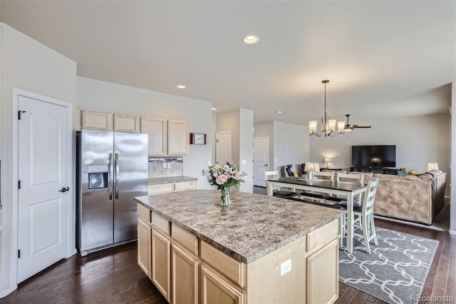 kitchen with a center island, stainless steel fridge with ice dispenser, dark wood-type flooring, and light brown cabinetry