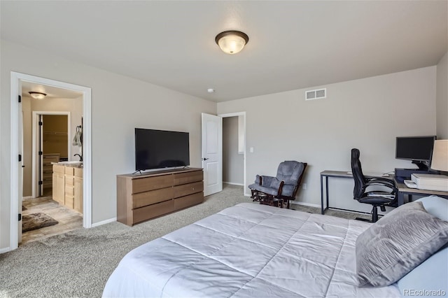 carpeted bedroom featuring ensuite bathroom