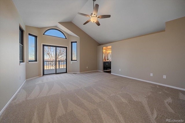 unfurnished living room with lofted ceiling, light colored carpet, and ceiling fan