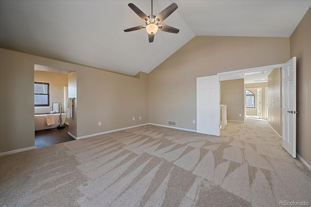 unfurnished living room featuring ceiling fan, light carpet, and lofted ceiling