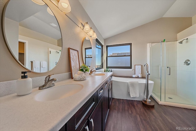 bathroom with vanity, walk in shower, hardwood / wood-style floors, and vaulted ceiling