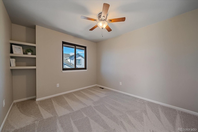 spare room featuring ceiling fan and carpet