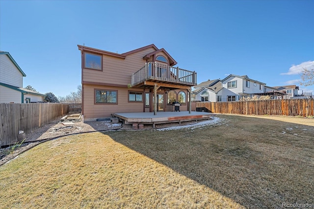 back of house featuring a yard and a wooden deck