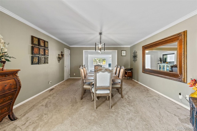 dining area with a notable chandelier, ornamental molding, and light colored carpet