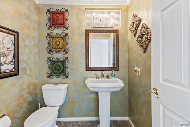 bathroom with sink, crown molding, and toilet