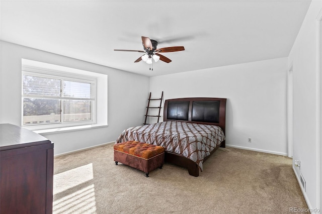 bedroom with ceiling fan and light carpet