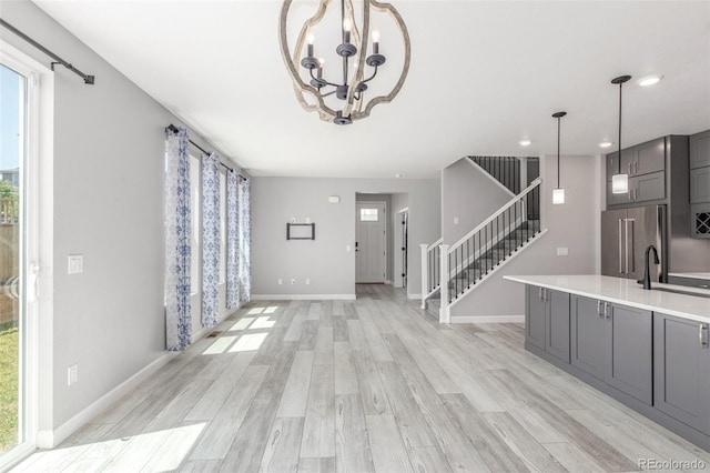 3338 Ireland Moss St, Castle Rock, CO 80109 - foyer featuring stairs, plenty of natural light, light wood-style flooring, and a chandelier