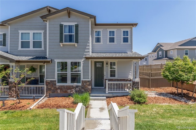 3338 Ireland Moss St, Castle Rock, CO 80109 - view of front facade featuring covered porch, stone siding, and roof with shingles