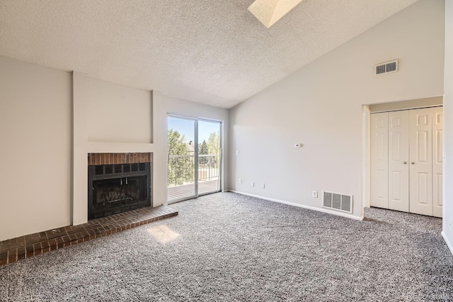 4899 S Dudley St Unit 20G, Littleton, CO 80123 - unfurnished living room with carpet floors, a brick fireplace, a textured ceiling, baseboards, and high vaulted ceiling
