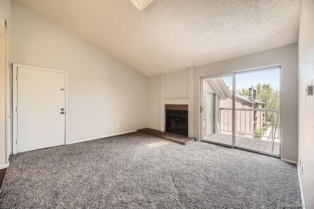 4899 S Dudley St Unit 20G, Littleton, CO 80123 - unfurnished living room with carpet, vaulted ceiling, a fireplace, and a textured ceiling