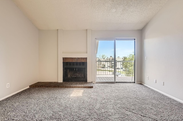 4899 S Dudley St Unit 20G, Littleton, CO 80123 - unfurnished living room featuring carpet, a textured ceiling, a brick fireplace, and baseboards
