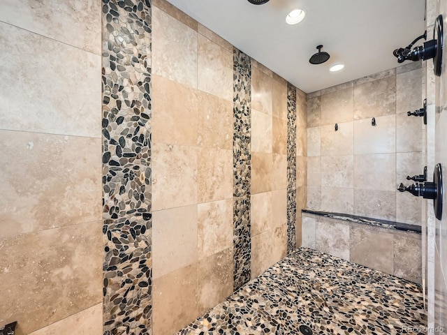 full bathroom with tiled shower and recessed lighting