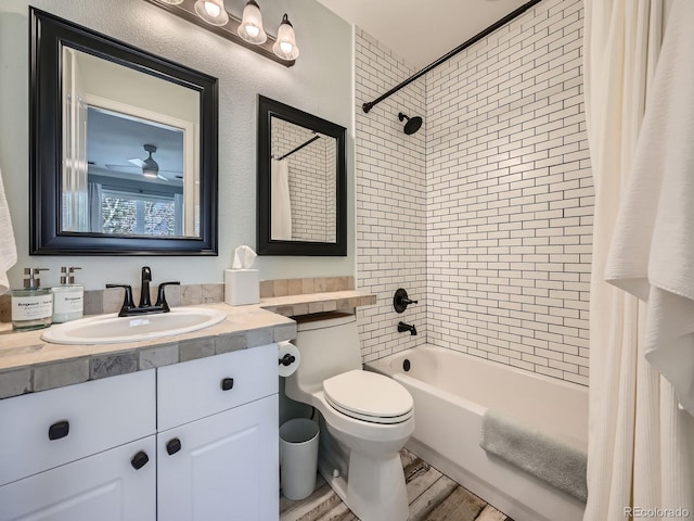 full bath with a textured wall, toilet, shower / tub combo with curtain, wood finished floors, and vanity