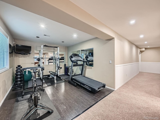 exercise area with dark wood-style floors, recessed lighting, visible vents, and baseboards