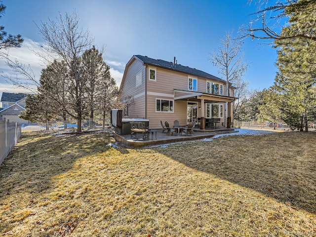 rear view of property with a patio area, a fenced backyard, a lawn, and a hot tub