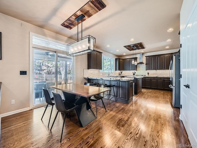 dining room featuring baseboards, recessed lighting, and dark wood-style flooring