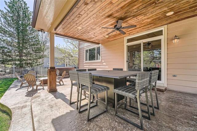 view of patio / terrace featuring fence, outdoor dry bar, and a ceiling fan