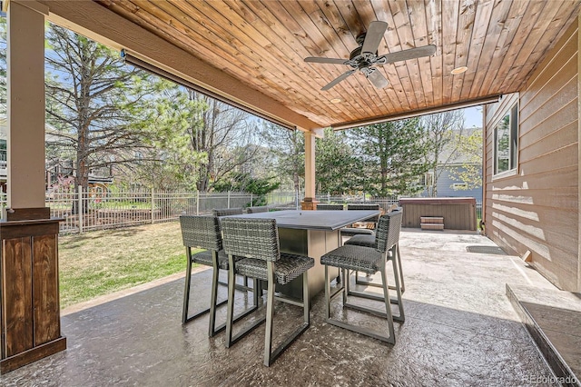 view of patio featuring a fenced backyard, outdoor dry bar, and ceiling fan