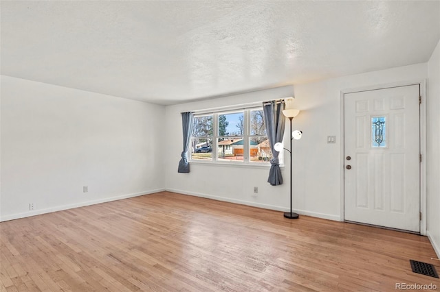 2613 Wren Dr, Colorado Springs, CO 80909 - entrance foyer with light wood-style floors, baseboards, and visible vents
