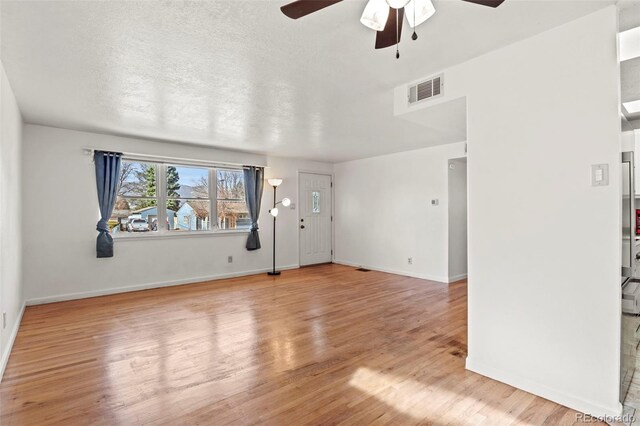 2613 Wren Dr, Colorado Springs, CO 80909 - unfurnished living room with wood finished floors, baseboards, a ceiling fan, and visible vents