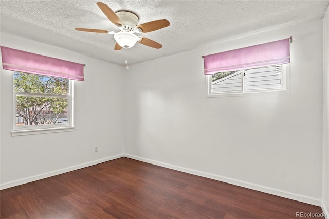 2613 Wren Dr, Colorado Springs, CO 80909 - spare room featuring a wealth of natural light, wood finished floors, and a textured ceiling