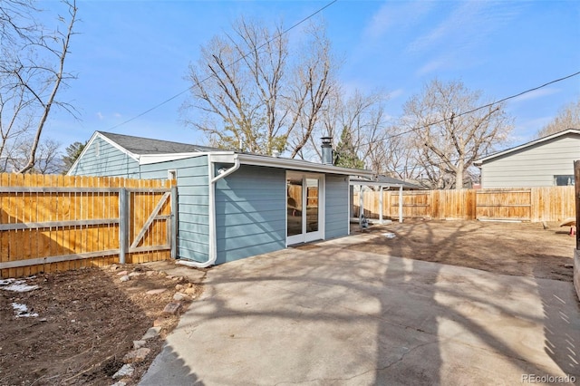 2613 Wren Dr, Colorado Springs, CO 80909 - back of property with a patio area, a fenced backyard, and driveway