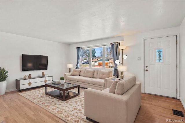 2613 Wren Dr, Colorado Springs, CO 80909 - living area featuring visible vents, baseboards, and wood finished floors