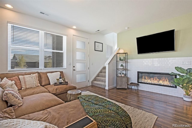 living room featuring dark hardwood / wood-style floors and a fireplace