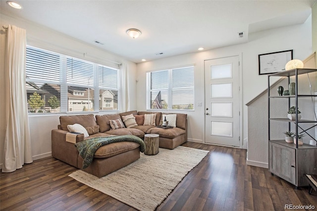 living room with dark hardwood / wood-style flooring