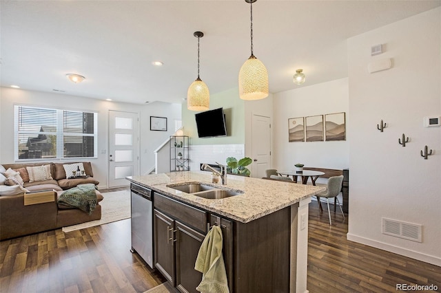 kitchen featuring dishwasher, sink, hanging light fixtures, light stone countertops, and dark brown cabinets