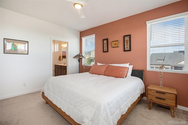 carpeted bedroom featuring ensuite bath and ceiling fan