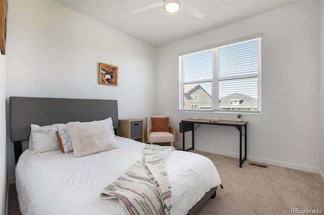 bedroom with ceiling fan and light carpet