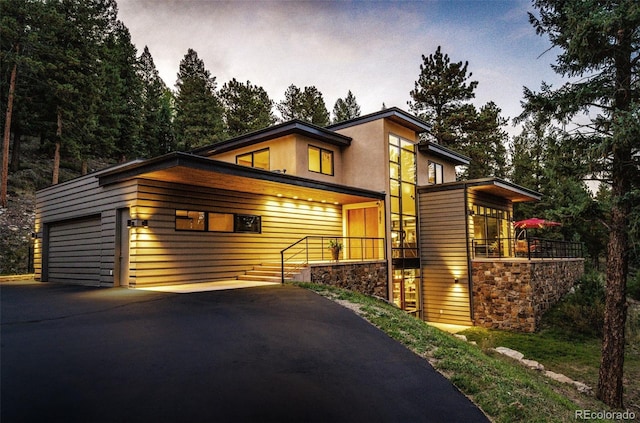 32651 Buffalo Creek Rd, Evergreen, CO 80439 - contemporary home with stone siding, stucco siding, and asphalt driveway