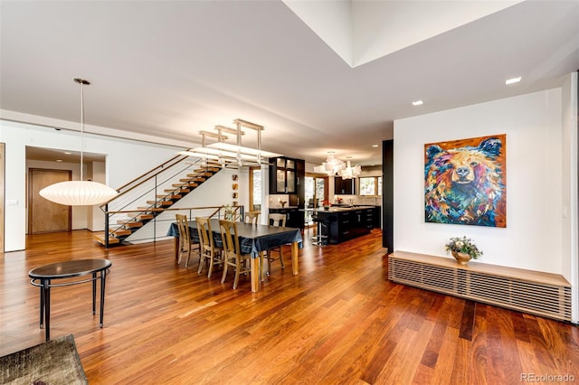 32651 Buffalo Creek Rd, Evergreen, CO 80439 - dining area featuring wood finished floors, a chandelier, and stairway