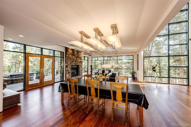 32651 Buffalo Creek Rd, Evergreen, CO 80439 - dining space with plenty of natural light, wood finished floors, and a wall of windows